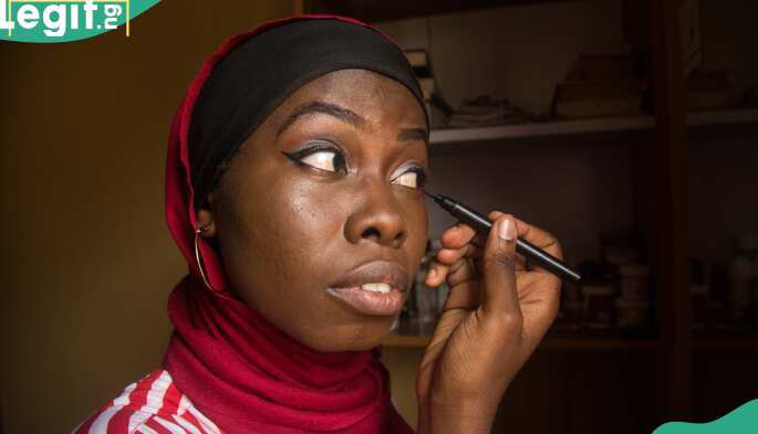 Lady applies makeup on her face