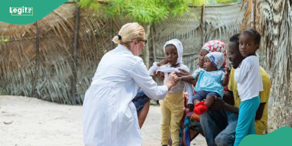 Health practitioner attends to ailing children in Africa