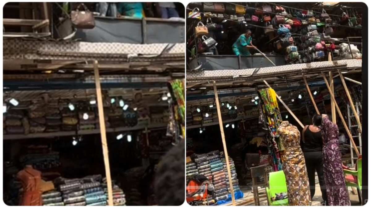 Two women fight with stick in the market, prevents the other from building roof